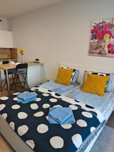 a bedroom with a bed with blue pillows on it at Comfort flat with great location in Prague