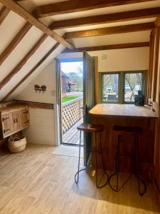 a kitchen with a bar with a view of a porch at The Granary in Hurstpierpoint