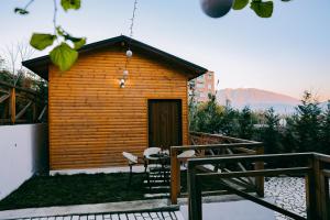a small wooden cabin with a table and chairs at Berat Hill Cabins in Berat