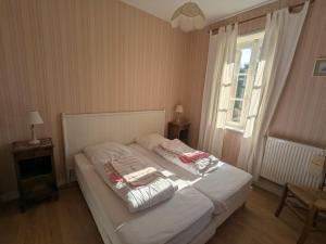 a bedroom with a bed with two pillows on it at Gîte de Navarre in Billy