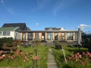 a large house with a yard with flowers at R&M Boutique in Lijnden