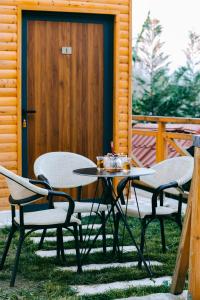 two chairs and a table on a patio at Berat Hill Cabins in Berat +2 photos