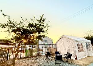 a group of chairs and a tent in a yard at 휘게스테이 in Sejong