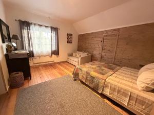 a bedroom with a bed and a chair in it at Valhalla Hytte in Oppdal