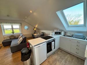 a kitchen and living room with a couch and a window at Room with a View in Aldergrove