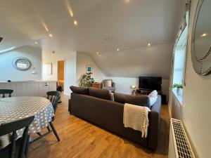 a living room with a couch and a table at Room with a View in Aldergrove