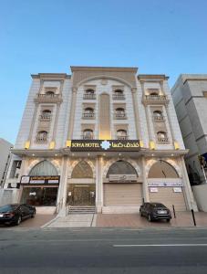 a building with two cars parked in front of it at فندق صها in Ash Shishah
