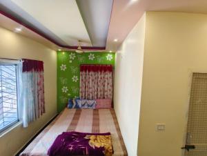 a small room with a bed in the corner at Maa durga lodge in Navadwīp