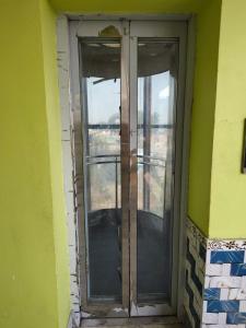 a door with two glass windows on a building at Maa durga lodge in Navadwīp +1 photo
