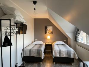 two beds in a room with a attic at Akkeri Guesthouse in Stykkishólmur