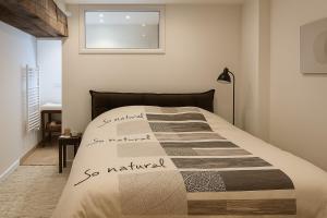 a bedroom with a bed with writing on it at La Maison des Templiers in Couches