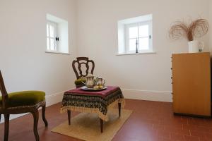 a room with a chair and a table with a bowl on it at La Maison des Templiers in Couches