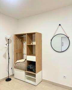 a bedroom with a bed and a mirror on the wall at Casa do Pastor - Vale de Alfaia in Sobral do Campo