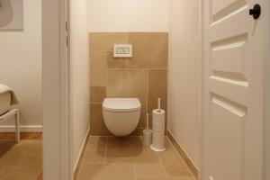 a small bathroom with a toilet in a room at La Maison des Templiers in Couches +4 photos