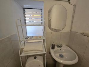 a bathroom with a sink and a toilet and a mirror at Magnolia Andina Hostel in Cusco +38 photos