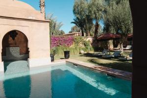 a swimming pool in the yard of a house at Villa Riad Marrakech in Najem