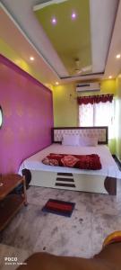 a bedroom with a large bed in a room at Maa durga lodge in Navadwīp