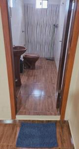 a bathroom with a toilet and a sink at Residencia Guadalupe in Colonia Río Verde