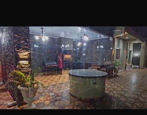 a large room with a table and a stone floor at Residencia Guadalupe in Colonia Río Verde