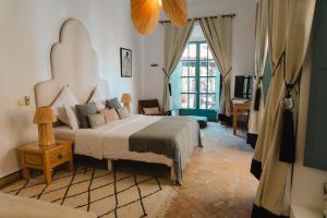 a bedroom with a large bed and a window at Villa Riad Marrakech in Najem +46 photos