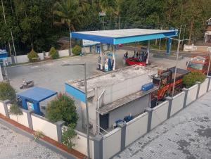 a gas station with a blue gas pump at PURAYIL Rooms in Kozhikode