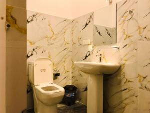 a bathroom with a toilet and a sink at Hasi Villa in Ahungalla +37 photos