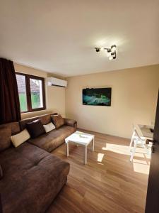 a living room with a couch and a table at Charshiq Guest House in Veliko Tŭrnovo