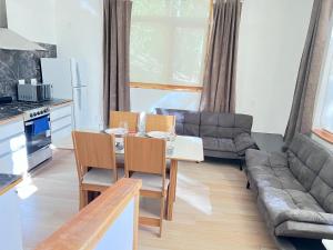 a living room with a table and a couch at Tranquila y moderna en el bosque in San Carlos de Bariloche