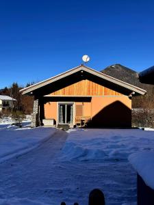 a building with a lot of snow in front of it at Chalet Ausweger - Strobl am Wolfgangsee in Strobl