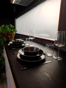 a table with plates and wine glasses on it at KotkaPesa in Vihtra +7 photos