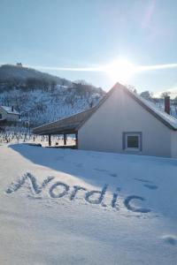 a house with the word snow written in the snow at Somló Nordic in Somlószőlős