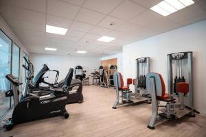 a gym with treadmills and exercise equipment in a room at ZEcamping 4 animaux acceptés hammam sauna piscine et soirées animées in Espelette