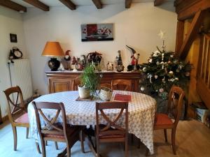 a dining room with a table and a christmas tree at Chalet La Grange de Madi in Muhlbach-sur-Munster