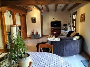 a living room with a couch and a table at Chalet La Grange de Madi in Muhlbach-sur-Munster