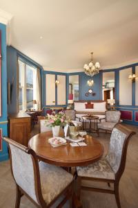 a living room with a table and chairs at The Ambassador Hotel in Inverness