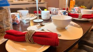 a table with red napkins and a plate with a cup at St Anthonys B&B in Dungarvan