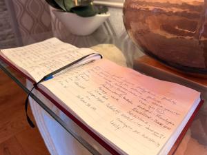 a book sitting on top of a table with a vase at St Anthonys B&B in Dungarvan