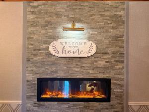 a fireplace with a sign that reads welcome to your homes at St Anthonys B&B in Dungarvan