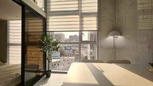 a dining room with a table and a large window at Arbo Unit in Seoul