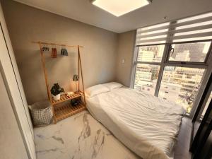 a bedroom with a bed and a large window at Arbo Unit in Seoul