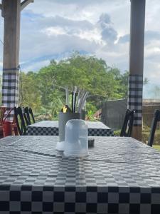a table with a black and white checkered table cloth at AJA Homestay in Pronojiwo