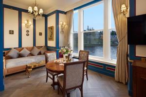a dining room with a table and a couch and a window at The Ambassador Hotel in Inverness