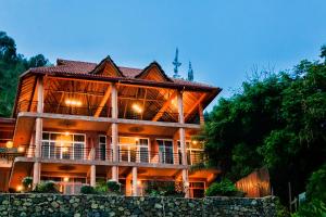 a large building with a fence in front of it at Hakuna Matata Lodge in Gisenyi