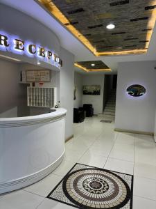 a lobby of a store with a sign on the ceiling at Ankara Efes Otel in Altındağ