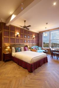 a large bedroom with a large bed and a table at The Ambassador Hotel in Inverness