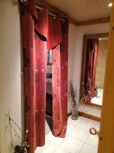 a group of red curtains in a room at Chalet La Grange de Madi in Muhlbach-sur-Munster +21 photos