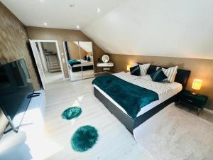 a bedroom with a large bed with two green furry pillows at Spacious home in quiet surroundings in Schwanden