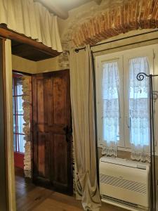 a room with a door and windows and a radiator at Gite rustique de charme chez Santa é Pasquà in San-Martino-di-Lota