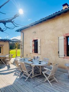 a patio with a table and chairs on a deck at La Hurre in Montiron