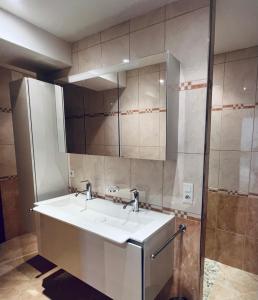 a bathroom with a sink and a mirror at La Hurre in Montiron +16 photos